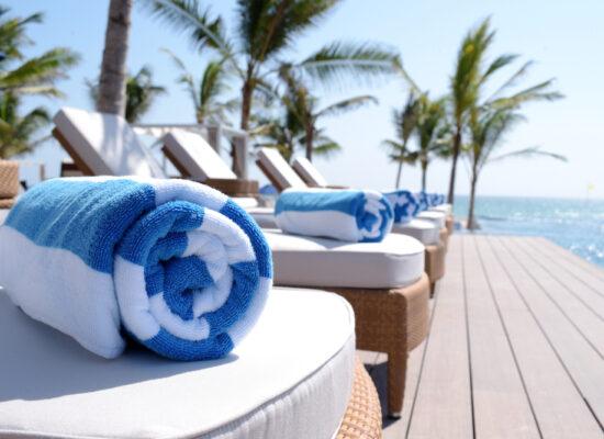 Arbemu towels - rolled-towels-on-sunbeds-by-pool, supplier, wholesaler in Turkey