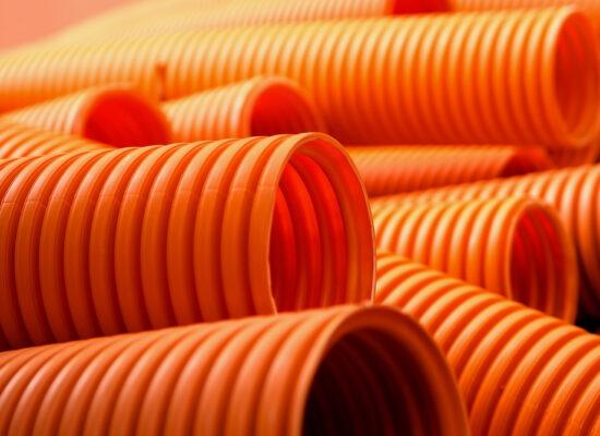 Arbemu, construction material, pipe - orange-plastic-pipe-background, supplier, wholesaler, in Turkey, Türkei, Turquie
